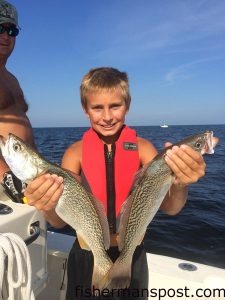 Preston Fisher (age 10), of Greensboro, NC, with a pair of gray trout that struck live finger mullet at the Marriott Reef.