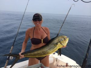 Sarah Rollason, of Kill Devil Hills, with a 20 lb. cow dolphin hooked 6 miles off Rodanthe while she and her husband Rich were fishing on the "Spider Wire."