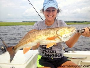 Jordan Terry, of Wilmington, with her first red drum, a 25" fish she hooked on a live finger mullet while fishing the Cape Fear River with Chris Aydlett.