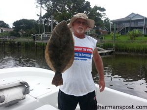 Steve Greene, of Shelby, NC, with a 26", 7.65 lb. flounder that he hooked on a live finger mullet while fishing inshore near Holden Beach with his sons Chad and Jeff and grandson Dustin.