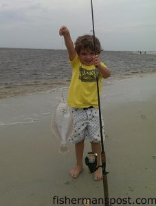 Samuel Mihaly (age 4), with a flounder that struck a strip of mullet in Carolina Beach Inlet.