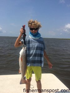 Macon Merriman (age 11), of Raleigh, with a red drum that inhaled a chunk of mullet in the Albermarle Sound near Nags Head.
