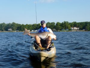 Dan Furimsky, of Greenville, NC, with a 49" red drum that bit a popping cork rig while he was kayak fishing the Neuse River.