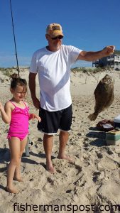 David Embrey, of King George,VA, with a flounder he hooked on a buctkail tipped with a strip bait in the Hatteras Village surf.