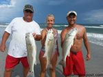 Doug, Brandy, and Josh Kelly, of Topsail Beach, with the results of a triple red drum hookup they found while surf fishing the local beachfront. The fish on the left was over-slot and released after the photo.