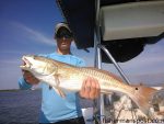 Riley Larsen, of Sewickley, PA, with a red drum that attacked a live bait near Bald Head Island while he was fishing with Capt. Greer Hughes of Cool Runnings Charters.