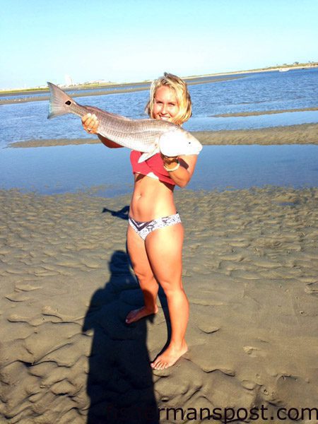 Katelyn Kincer, of the Ocean Isle Fishing Center, with a red drum she hooked in Tubbs Inlet while fishing with Taylor Henkel. The red fell for a live finger mullet.