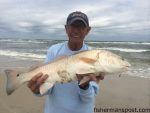 John Newbold, of TW's Tackle, with a puppy drum that he hooked while surf fishing the Nags Head beach at Ramp 4 near Oregon Inlet.