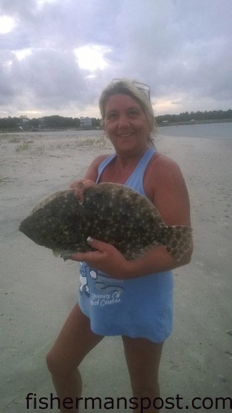 Renee Bennett, of Asheboro, NC, with a 20″ flounder she hooked on a Gulp shrimp in Shallotte Inlet.