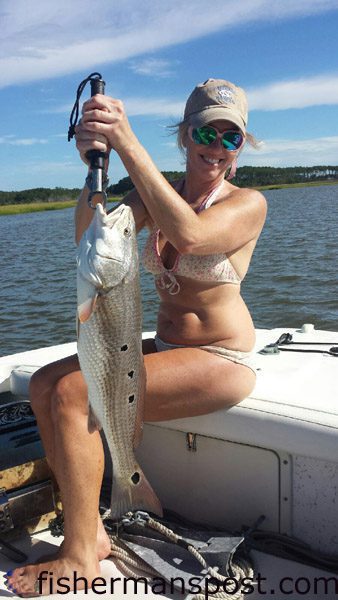 Beth Lee with her first red drum, a 28″ fish that bit a live finger mullet under a popping cork in a Beaufort-area marsh while she was fishing with her boyfriend, Capt. Chris Kimrey of Mount Maker Charters.