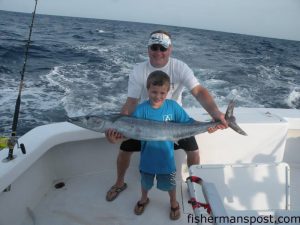 Ricahrd and Connor Mcinnis, of Rockingham, NC, with Connor's first offshore fish, a wahoo that he landed while trolling offshore of Hatteras Inlet with on the "Hatteras Fever II" with Capt. Buddy Hooper.