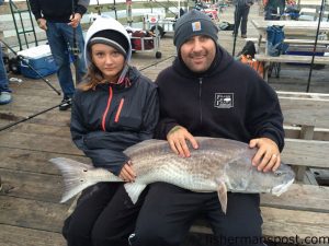 Summer and Eric Bregman with Summer's first red drum, a 41" fish she caught and released off Avalon Pier after it struck a cut bait.