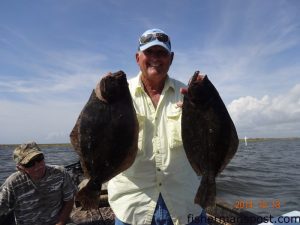 Curtis Pelt with 18" and 20" flounder he hooked on Gulp baits near Swan Quarter.