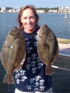 Linda Mudaro with a piar of flounder she and her husband hooked behind Portsmouth Island on live finger mullet.