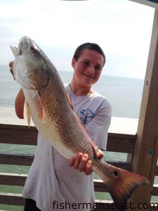 Andrew Midgett with a slot red drum he hooked while bottom fishing from Jennette's Pier.