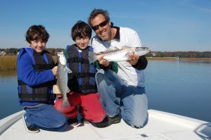 James (left), Owen (center), and Gary Hurley with a couple of the speckled trout they landed between eating donuts, drinking Powerade, and "racing" bobbers. They were drifting live shrimp in the Ocean Isle area with Capt. Kyle Hughes of Speckulator Inshore Fishing Charters.
