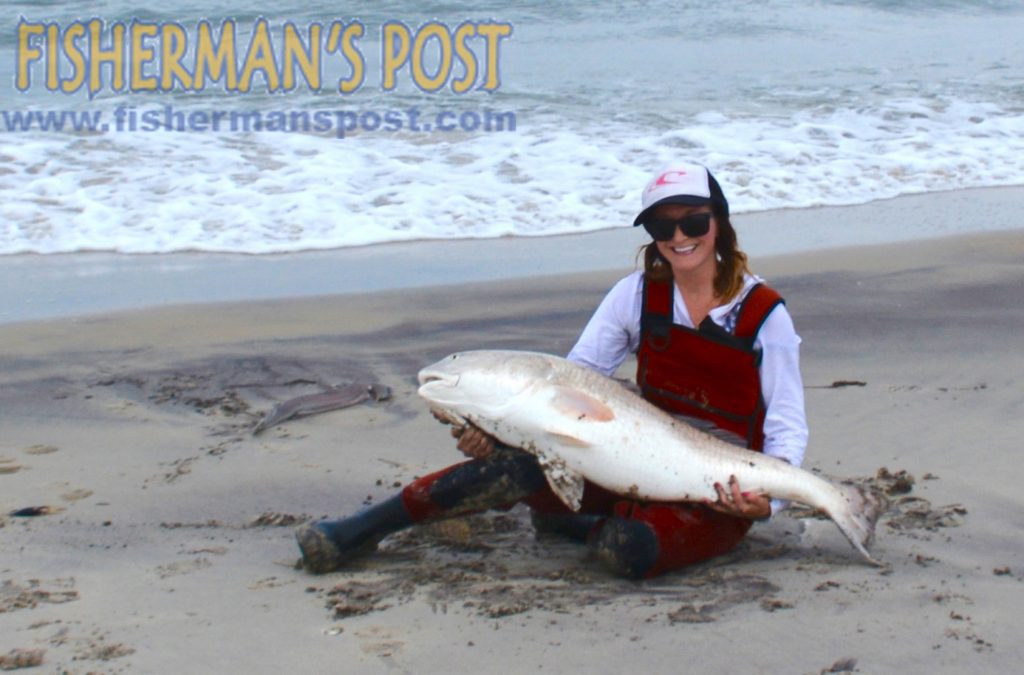 Mickie Warren, of Rodanthe, NC, with a 46" red drum that she hooked on a chunk of menhaden while surf casting at Cape Point in late March.