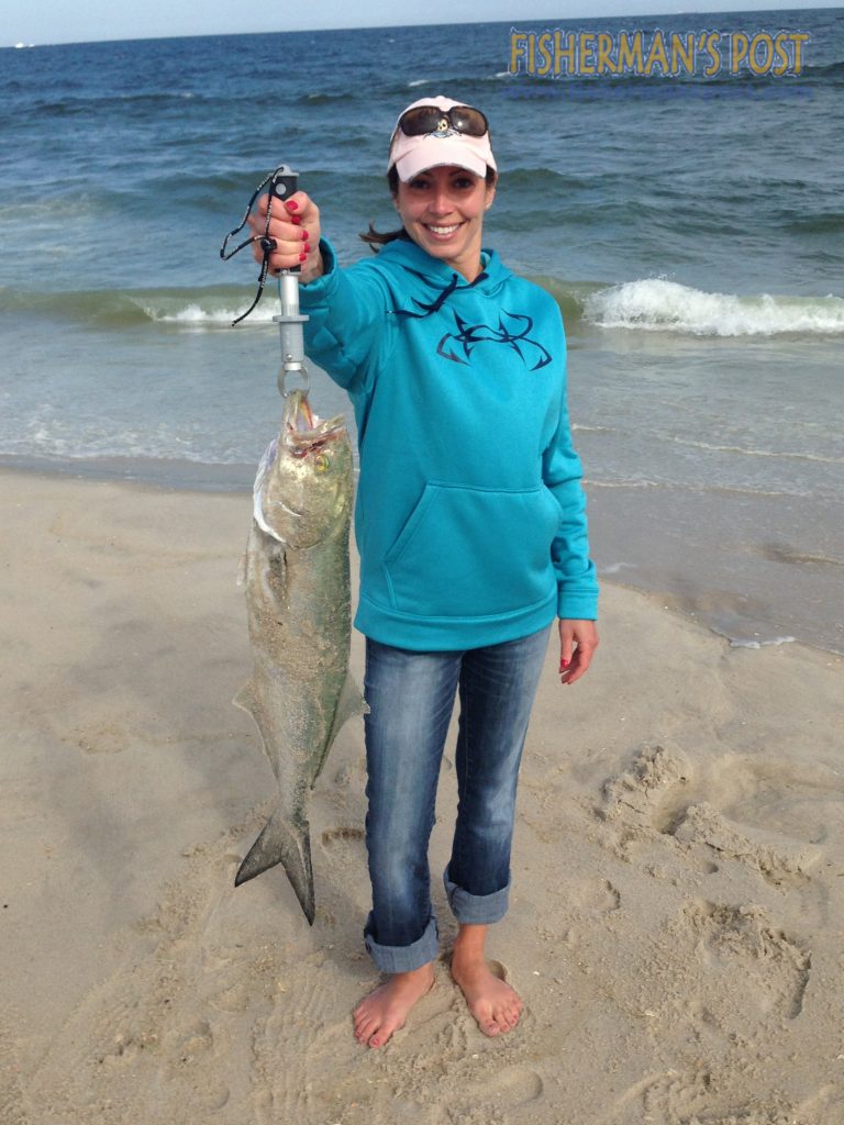 Christina W with one of many chopper bluefish she hooked while surf fishing the northern Outer Banks. Photo courtesy of TW's Tackle.