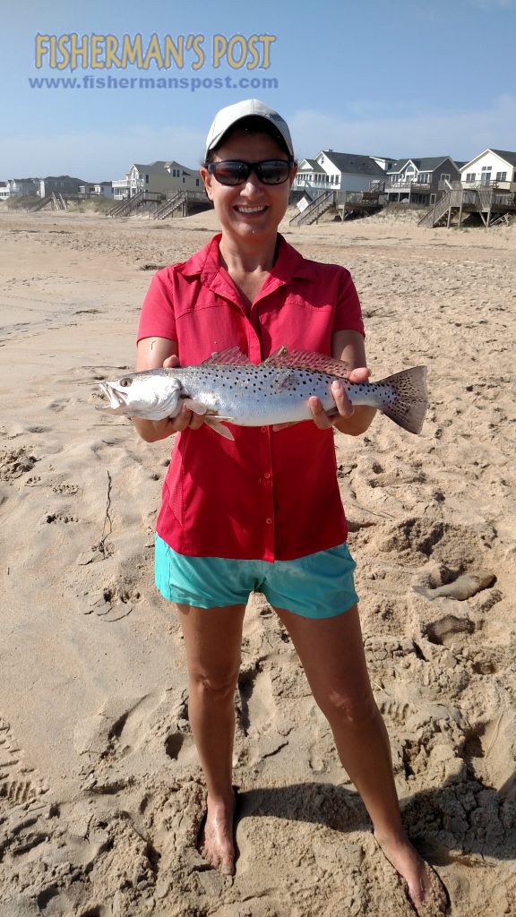 Joanne Torrence with a keeper speckled trout that she hooked from the beach on the northern Outer Banks. Photo courtesy of TW's Tackle.