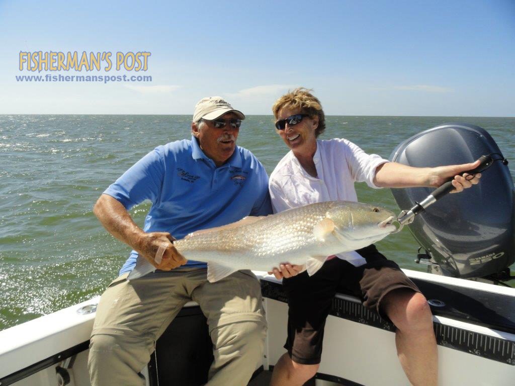 Capt. Rudy Gray, of "The Hook Up," and Larine Yates with a citation-class red drum that struck a chunk of tuna belly off Ocracoke Island.