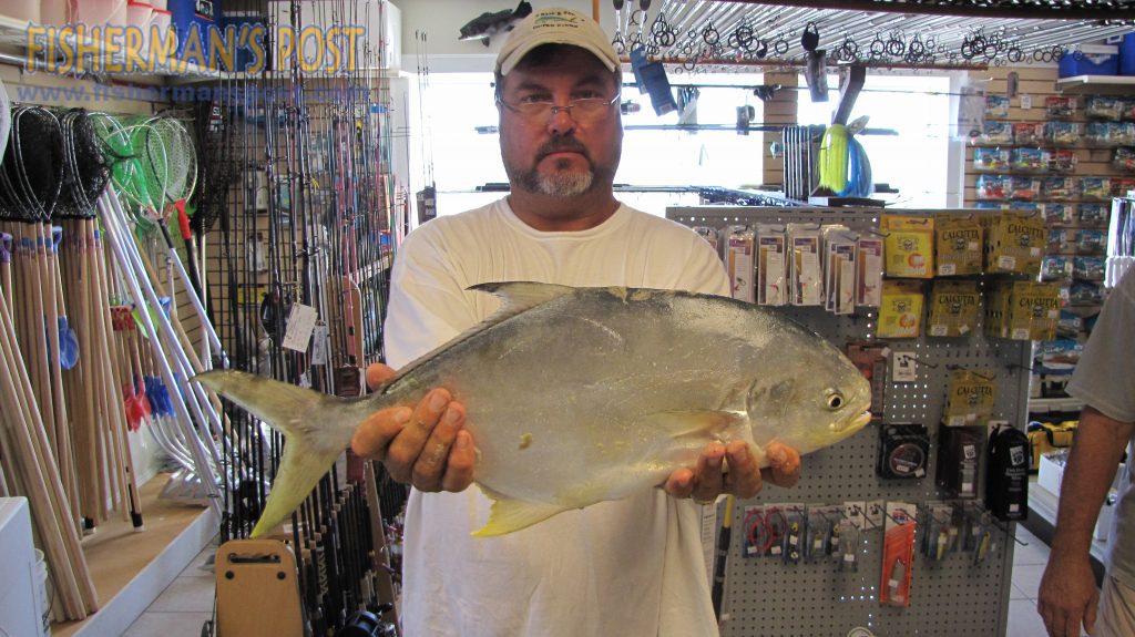 Percy Hutchens with a 4 lb., 11 oz. pompano that he hooked while surf fishing off Ramp 55 in Hatteras Village. Weighed in at Teach's Lair Marina.