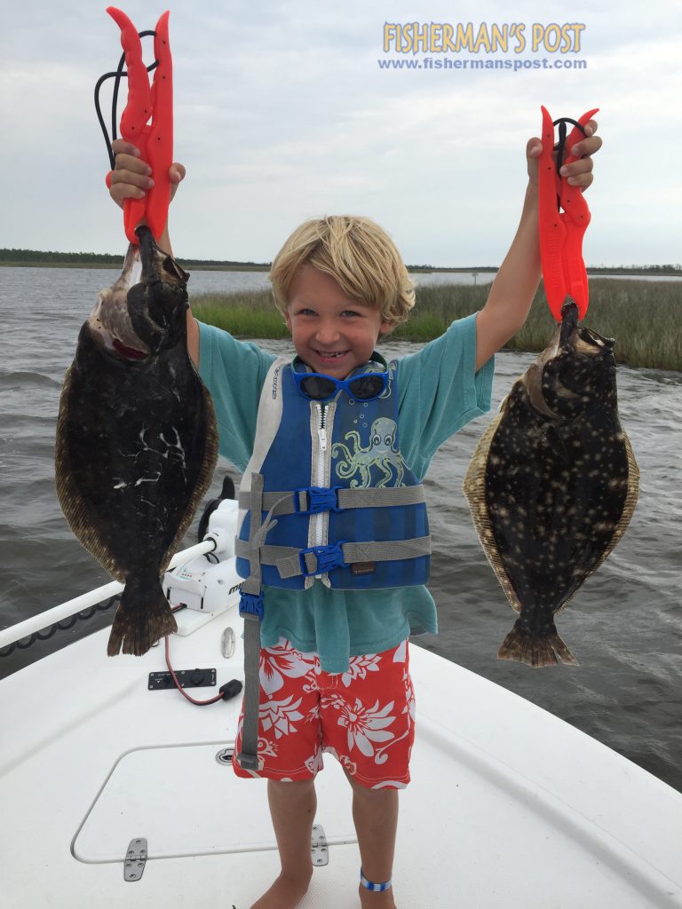 Parson Conway with 19" and 20" flounder he landed while fishing the Pamlico Sound with his father Stephen and David and Macon Merriman.