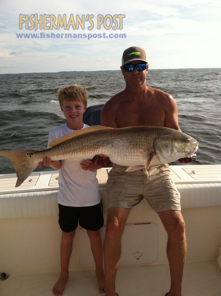 Bodie (age 7) and Kevin Taylor, of Surf City, NC, with a citation red drum that attacked a chunk of menhaden while they were fishing the lower Neuse River.